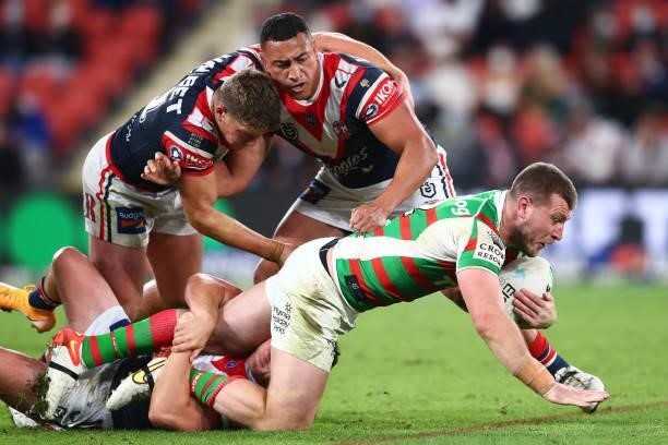 Jai Arrow of the Rabbitohs is tackled during the round 24 NRL match between the Sydney Roosters and the South Sydney Rabbitohs at Suncorp Stadium on...