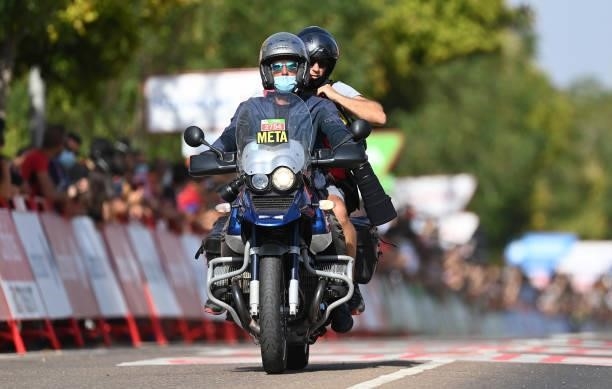 The motorcyclist Serge Seynaeve of Belgium and Tim de Waele of Belgium Photographer of Getty Images cross the finishing line after the 76th Tour of...