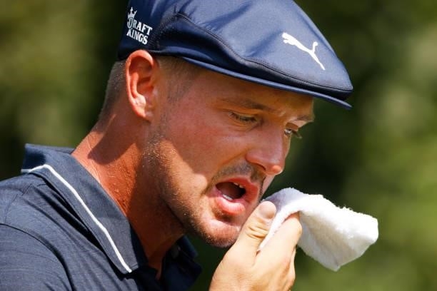 Bryson DeChambeau of the United States uses a towel as he walks from the second tee during the second round of the BMW Championship at Caves Valley...