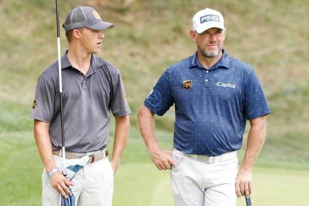 Lee Westwood of England talks with his caddie and son Sam Westwood on the eighth green during the second round of the BMW Championship at Caves...