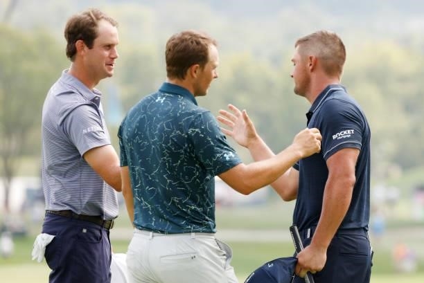 Harris English of the United States, Justin Thomas of the United States and Bryson DeChambeau of the United States shake hands after finishing on the...
