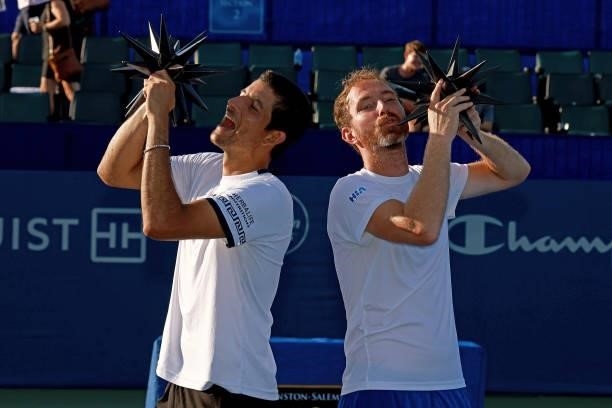Marcelo Arevalo of El Salvador and Matwe Middelkoop of Netherlands celebrate with their trophies after defeating Ivan Dodig of Croatia and Austin...