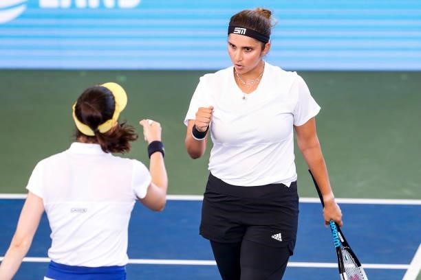 Sania Mirza of India celebrates with Christina McHale of the United States during the first set of their semifinal doubles match against Ulrikke...