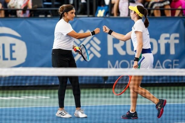 Sania Mirza of India celebrates with Christina McHale of the United States during the second set of their semifinal doubles match against Ulrikke...