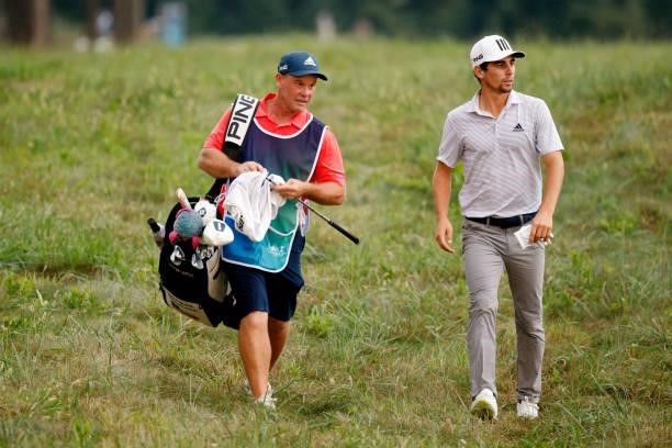 Joaquin Niemann of Chile walks with his caddie on the 16th hole during the second round of the BMW Championship at Caves Valley Golf Club on August...