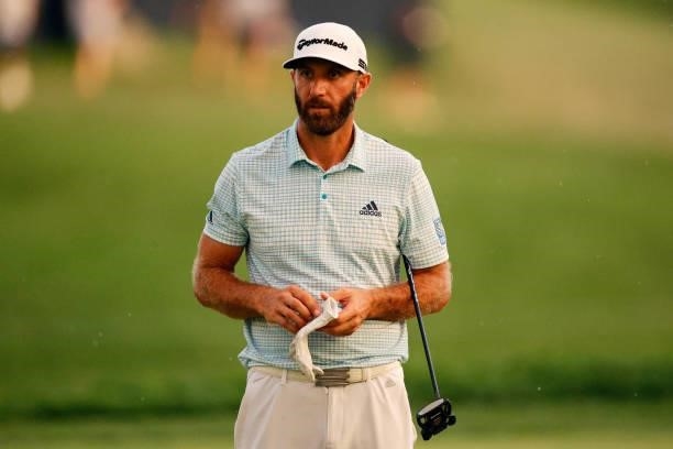 Dustin Johnson of the United States checks his yardage book on the 18th green during the second round of the BMW Championship at Caves Valley Golf...