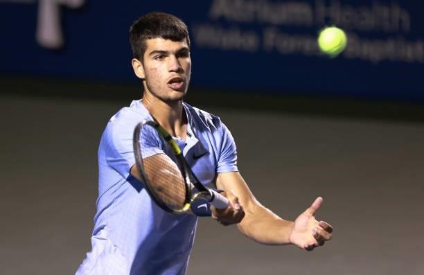 Carlos Alcaraz of Spain returns a shot to Mikael Ymer of Sweden during the semifinals of the Winston-Salem Open at Wake Forest Tennis Complex on...