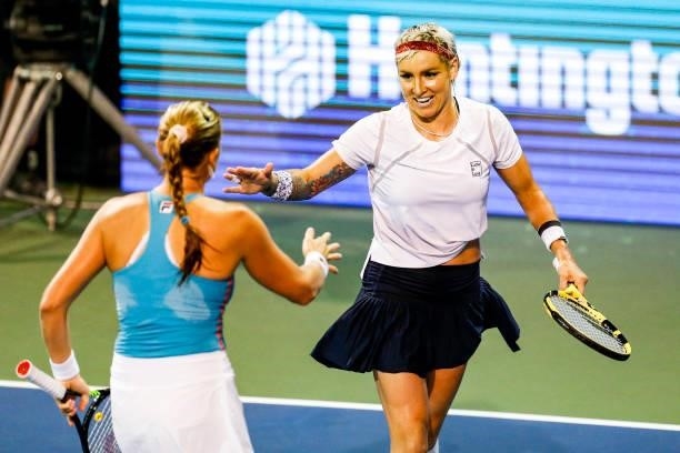 Bethanie Mattek-Sands of the United States celebrates with Shelby Rogers of the United States during the first set of their semifinal doubles match...