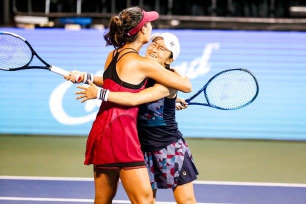 Ena Shibahara of Japan and Shuko Aoyama of Japan hug after winning in the tie break of their semifinal doubles match against Bethanie Mattek-Sands of...