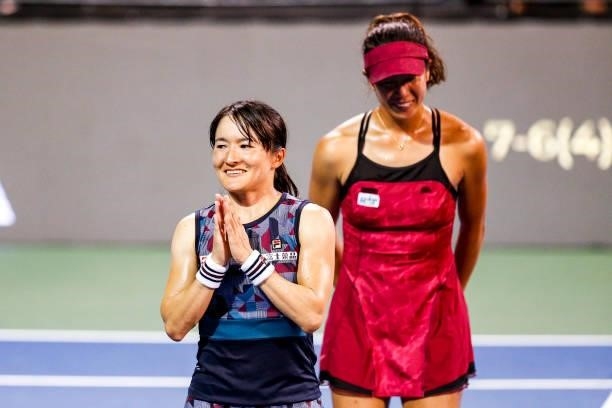 Shuko Aoyama of Japan and Ena Shibahara of Japan wave to fans after winning in the tie break of their semifinal doubles match against Bethanie...