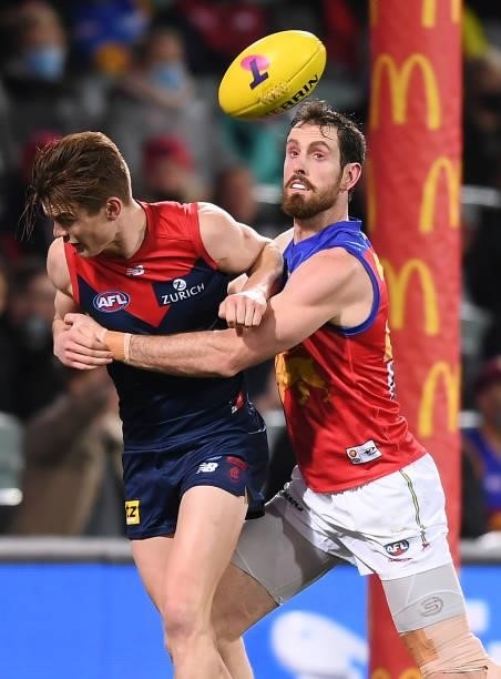 Bayley Frisch of the Demons competes with Grant Birchall of the Lions during the AFL First Qualifying Final match between Melbourne Demons and...