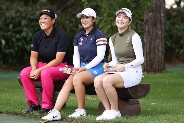 Haruka Kudo of Japan , Miyu Abe of Japan and Akira Yamaji of Japan smile during the third round of the Nitori Ladies at Otaru Country Club on August...