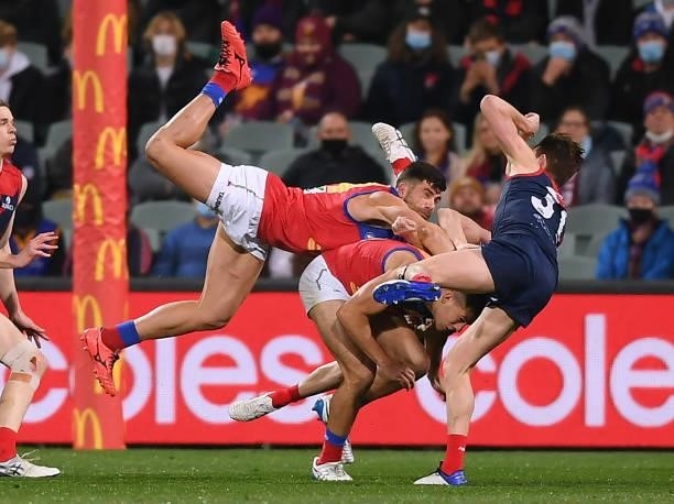 Marcus Adams of the Lions crashes into Kade Chandler of the Demons and Bayley Frisch of the Demons during the AFL First Qualifying Final match...
