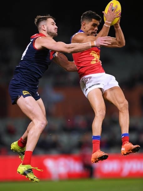 Charlie Cameron of the Lions marks in front of Joel Smith of the Demons during the AFL First Qualifying Final match between Melbourne Demons and...