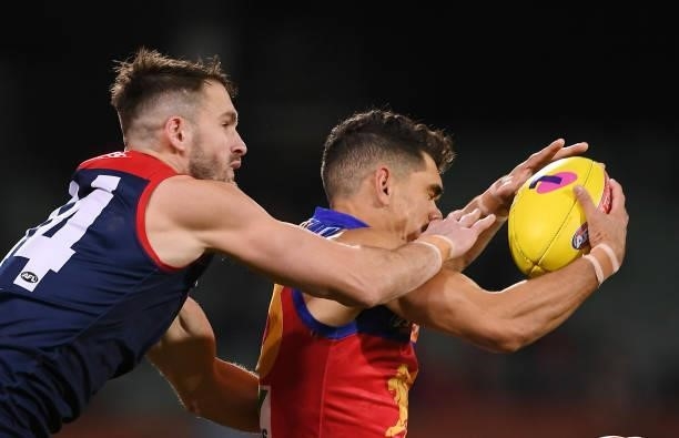 Charlie Cameron of the Lions marks in front of Joel Smith of the Demons during the AFL First Qualifying Final match between Melbourne Demons and...