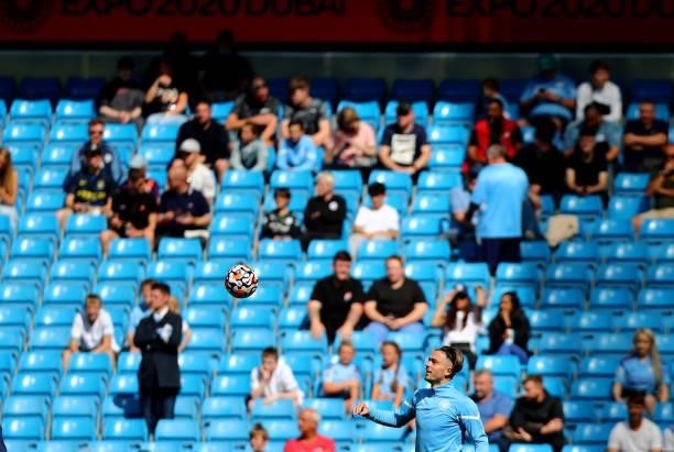 Jack Grealish of Manchester City warms up ahead of the Premier League match between Manchester City and Arsenal at Etihad Stadium on August 28, 2021...