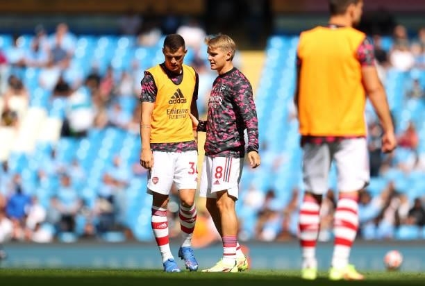 Granit Xhaka and Martin Odegaard of Arsenal speak during the warm up prior to the Premier League match between Manchester City and Arsenal at Etihad...
