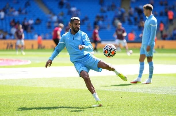 Riyad Mahrez of Manchester City warms up prior to the Premier League match between Manchester City and Arsenal at Etihad Stadium on August 28, 2021...