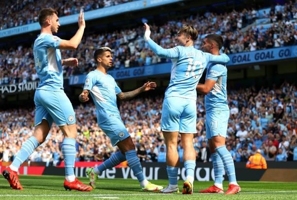 Ferran Torres of Manchester City celebrates with teammates Aymeric Laporte, Joao Cancelo, and Jack Grealish after scoring his team's second goal...
