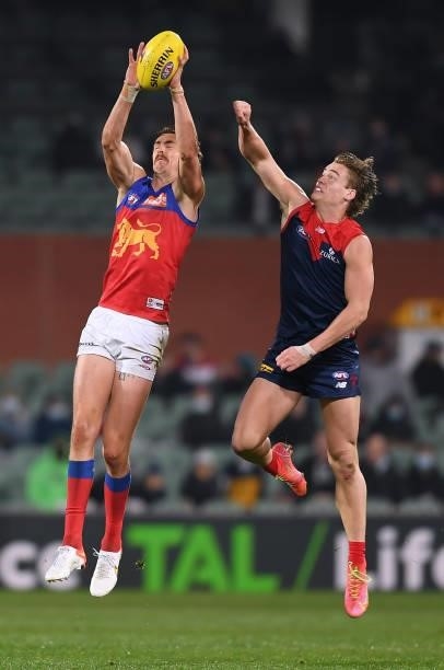Joe Daniher of the Lions marks in front of Trent Rivers of the Demons during the AFL First Qualifying Final match between Melbourne Demons and...