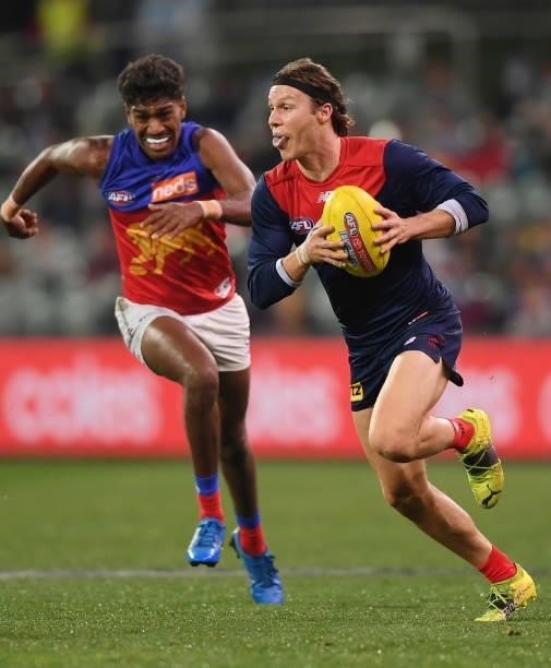 Ed Langdon of the Demons gets away from Keidean Coleman of the Lions during the AFL First Qualifying Final match between Melbourne Demons and...