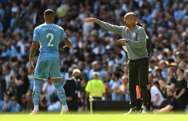 Pep Guardiola, Manager of Manchester City speaks with Kyle Walker of Manchester City during the Premier League match between Manchester City and...