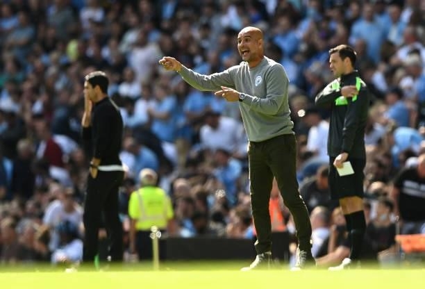 Pep Guardiola, Manager of Manchester City gives his team instructions during the Premier League match between Manchester City and Arsenal at Etihad...