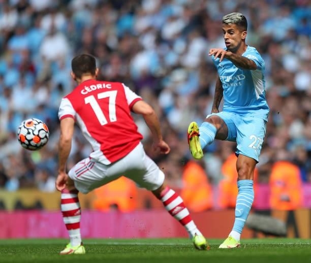 Joao Cancelo of Manchester City is challenged by Cedric Soares of Arsenal during the Premier League match between Manchester City and Arsenal at...