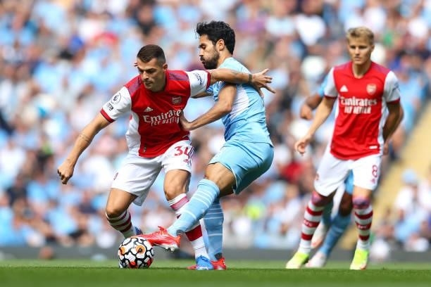 Granit Xhaka of Arsenal battles for possession with Ilkay Gundogan of Manchester City during the Premier League match between Manchester City and...