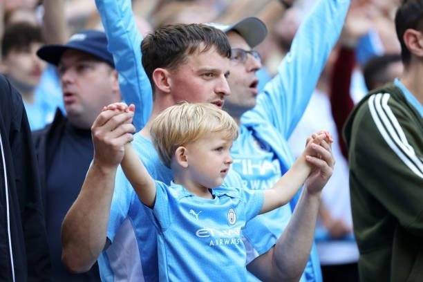 Fans of Manchester City look on from the crowd during the Premier League match between Manchester City and Arsenal at Etihad Stadium on August 28,...
