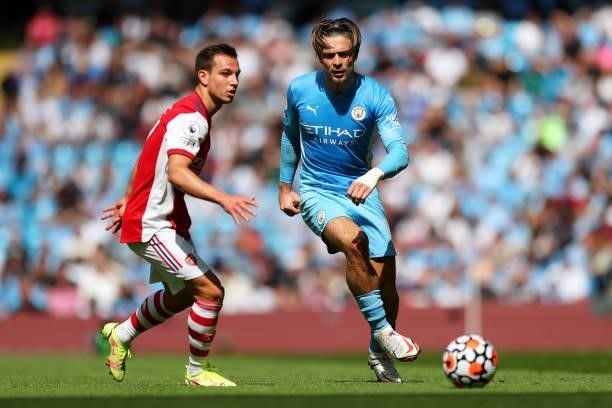 Jack Grealish of Manchester City battles for possession with Cedric Soares of Arsenal during the Premier League match between Manchester City and...