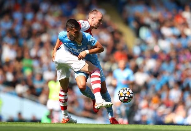 Ferran Torres of Manchester City battles for possession with Rob Holding of Arsenal during the Premier League match between Manchester City and...