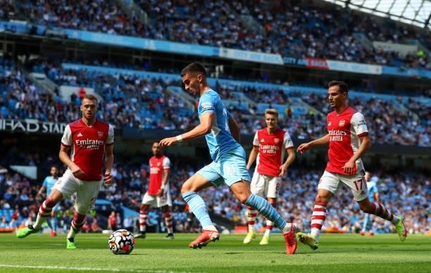 Ferran Torres of Manchester City controls the ball under pressure of Cedric and Calum Chambers of Arsenal during the Premier League match between...