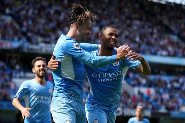 Gabriel Jesus of Manchester City celebrates after scoring their sides third goal with team mate Jack Grealish during the Premier League match between...