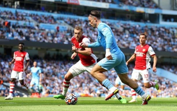 Jack Grealish of Manchester City battles for possession with Calum Chambers of Arsenal during the Premier League match between Manchester City and...