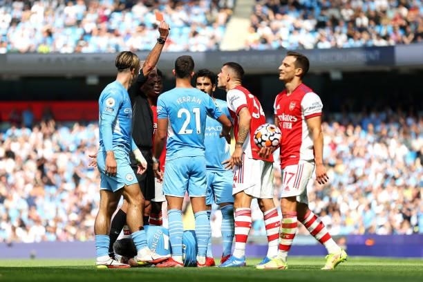 Referee Martin Atkinson awards Granit Xhaka of Arsenal a red card during the Premier League match between Manchester City and Arsenal at Etihad...