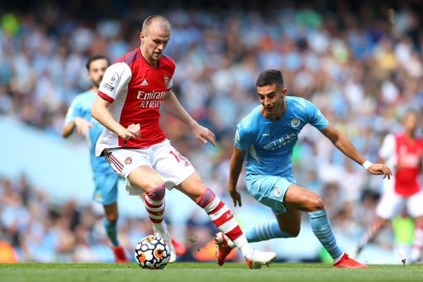 Rob Holding of Arsenal battles for possession with Ferran Torres of Manchester City during the Premier League match between Manchester City and...
