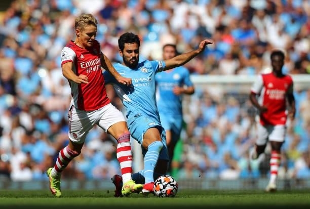 Ilkay Gundogan of Manchester City and Martin Odegaard of Arsenal in action during the Premier League match between Manchester City and Arsenal at...