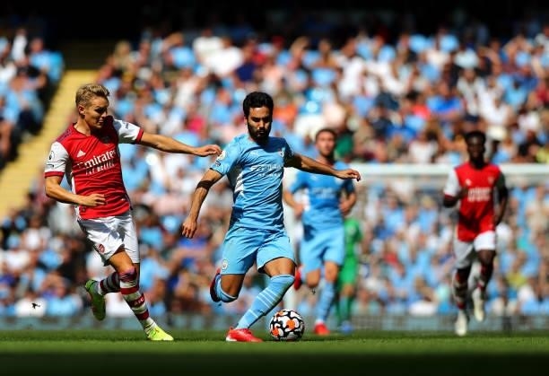 Ilkay Gundogan of Manchester City and Martin Odegaard of Arsenal in action during the Premier League match between Manchester City and Arsenal at...