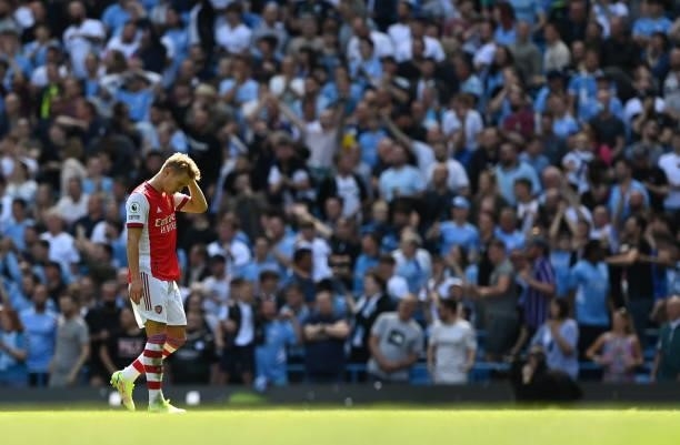 Martin Odegaard of Arsenal cuts a dejected figure during the Premier League match between Manchester City and Arsenal at Etihad Stadium on August 28,...