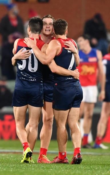 Trent Rivers of the Demons hugs Alex Neal-Bullen and Jack Viney of the Demons after the final siren during the AFL First Qualifying Final match...