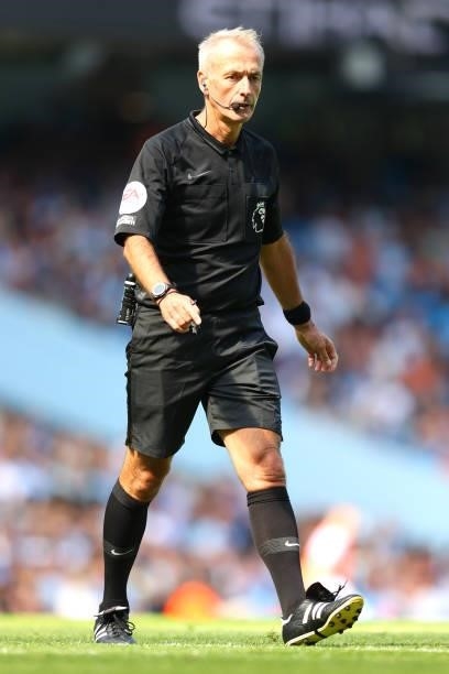 Match Referee Martin Atkinson looks on during the Premier League match between Manchester City and Arsenal at Etihad Stadium on August 28, 2021 in...