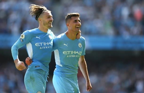 Rodrigo of Manchester City celebrates with teammate Jack Grealish after scoring their team's fourth goal during the Premier League match between...