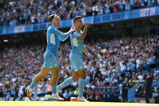 Rodrigo of Manchester City celebrates with teammate Jack Grealish after scoring their team's fourth goal during the Premier League match between...