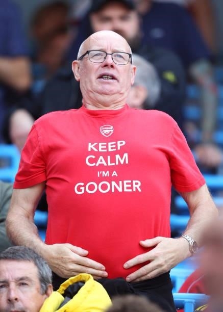 An Arsenal fan looks on during the Premier League match between Manchester City and Arsenal at Etihad Stadium on August 28, 2021 in Manchester,...