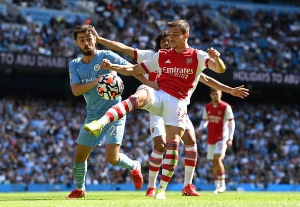 Cedric Soares of Arsenal controls the ball under pressure from Bernardo Silva of Manchester City during the Premier League match between Manchester...