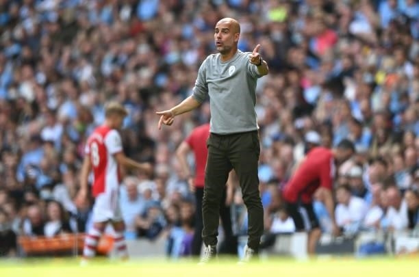 Pep Guardiola, Manager of Manchester City gives instructions to their side during the Premier League match between Manchester City and Arsenal at...
