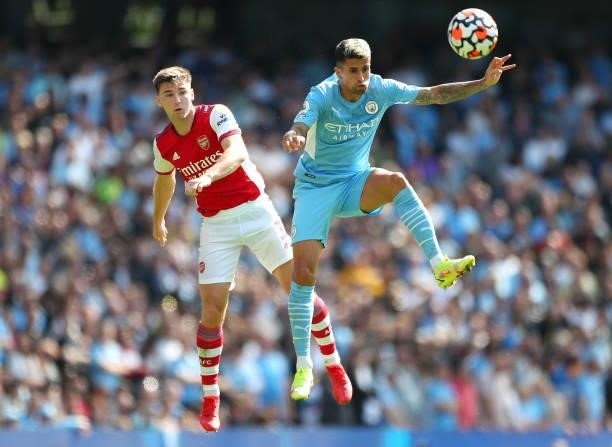 Kieran Tierney of Arsenal challenges for the high ball with Joao Cancelo of Manchester City during the Premier League match between Manchester City...