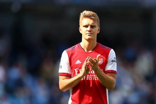Martin Odegaard of Arsenal applauds fans after the Premier League match between Manchester City and Arsenal at Etihad Stadium on August 28, 2021 in...