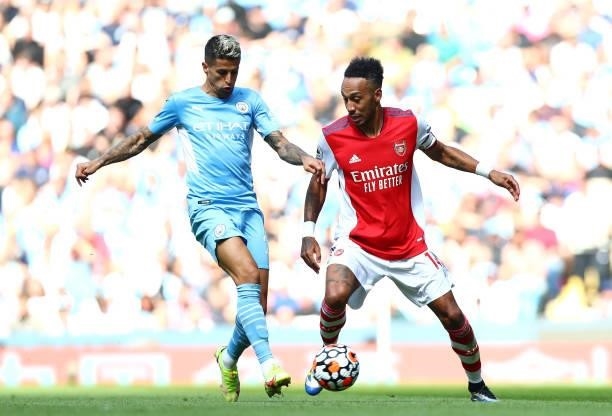 Joao Cancelo of Manchester City and Pierre-Emerick Aubameyang of Arsenal in action during the Premier League match between Manchester City and...